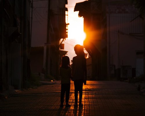 Family enjoying a peaceful walk on a quiet street at twilight